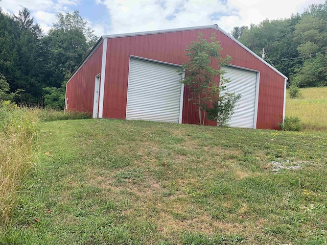 view of outbuilding with a garage and a yard