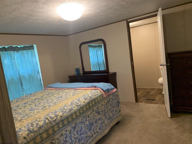 carpeted bedroom with a textured ceiling