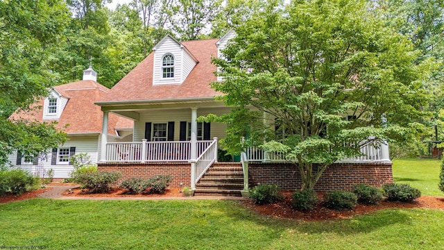 cape cod-style house with a front lawn and a porch