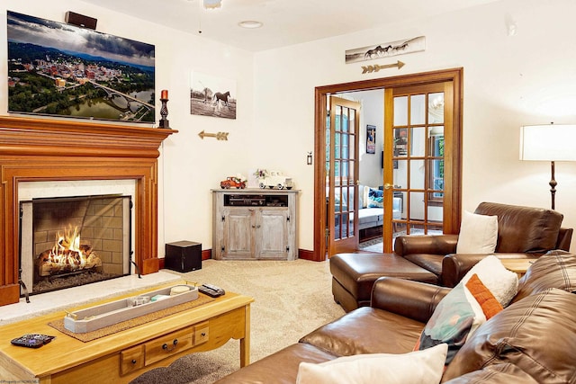 carpeted living room featuring ceiling fan and french doors