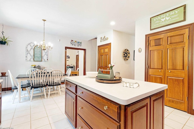 kitchen featuring decorative light fixtures, light tile patterned floors, an inviting chandelier, and a center island