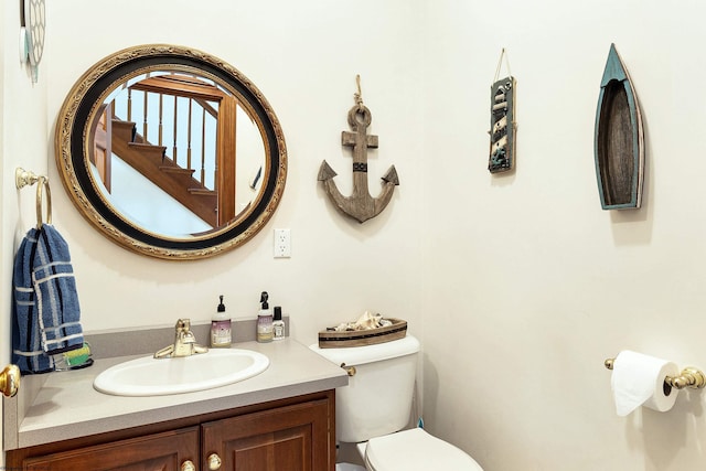 bathroom featuring toilet and vanity