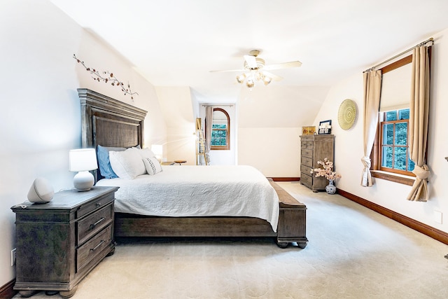 carpeted bedroom featuring ceiling fan and vaulted ceiling