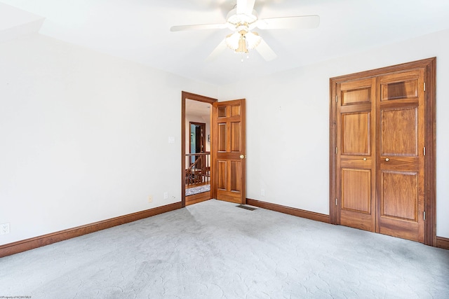 unfurnished bedroom featuring light carpet and ceiling fan