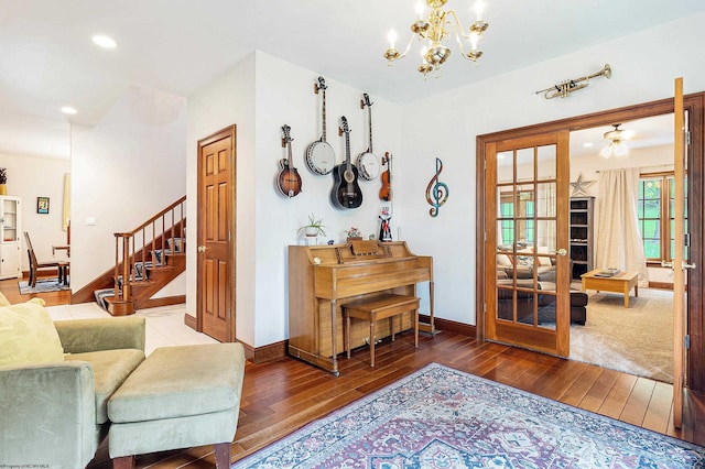 interior space with hardwood / wood-style flooring, french doors, and an inviting chandelier