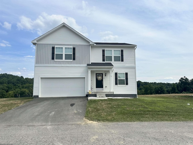 view of front property featuring a garage and a front yard