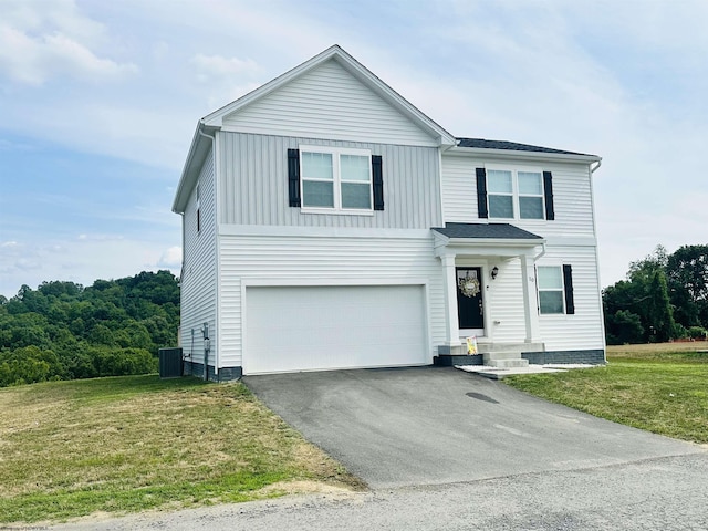 front of property with a garage, central AC unit, and a front lawn