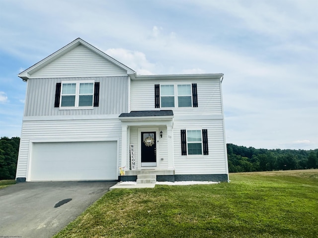 view of front of property featuring a garage and a front lawn