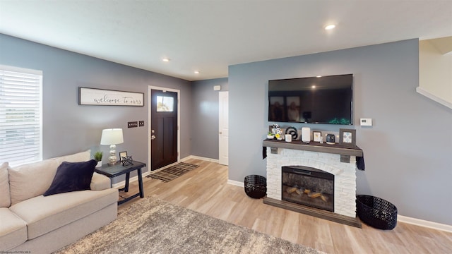 living room with a fireplace and light hardwood / wood-style floors