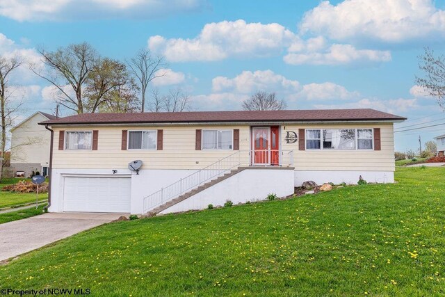 view of front of house with a garage and a front lawn