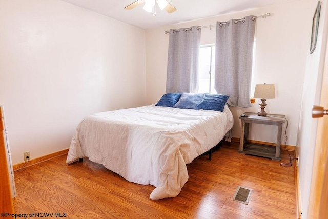 bedroom featuring hardwood / wood-style flooring and ceiling fan