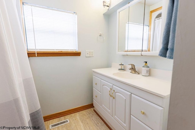 bathroom with vanity and hardwood / wood-style flooring