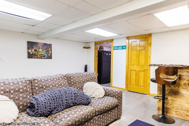 living room with a drop ceiling