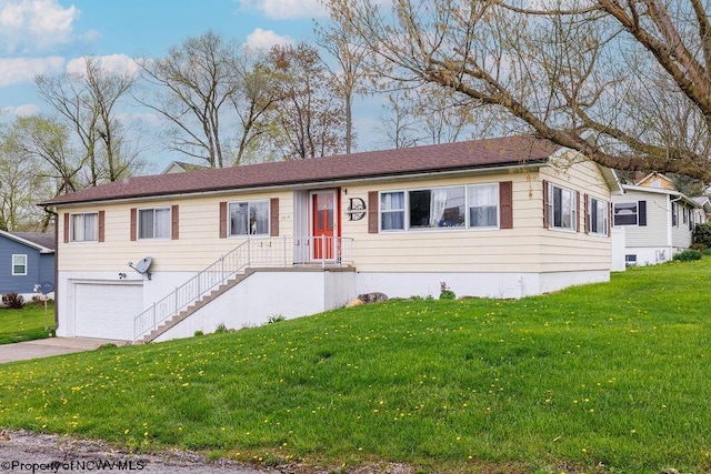 view of front of house featuring a garage and a front lawn