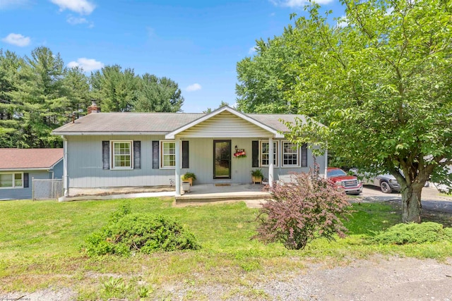 ranch-style home with covered porch and a front yard