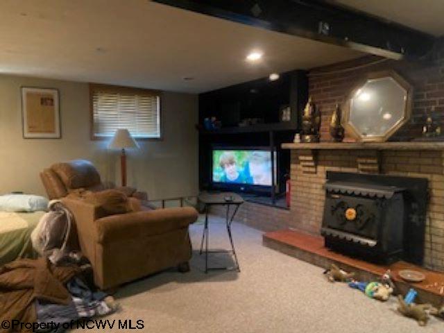 living room featuring a fireplace and carpet