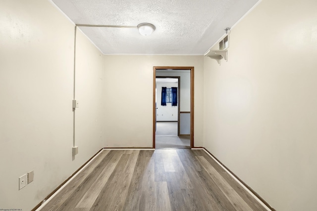 hall featuring hardwood / wood-style flooring and a textured ceiling