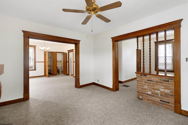 unfurnished living room featuring light carpet, a fireplace, and ceiling fan