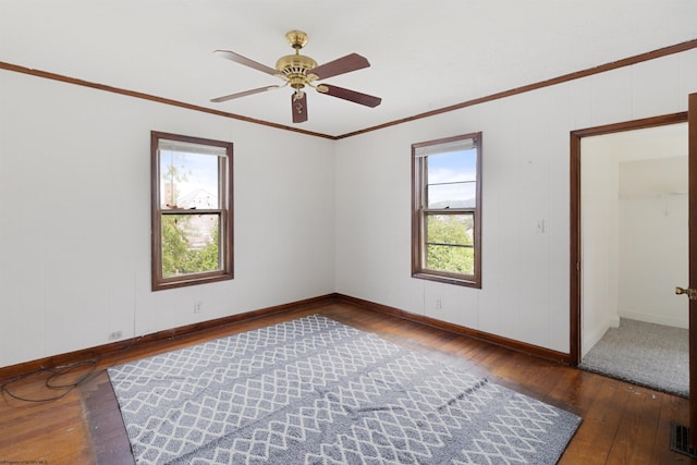 unfurnished bedroom featuring dark hardwood / wood-style floors, ornamental molding, and ceiling fan