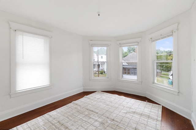 unfurnished room with dark hardwood / wood-style floors