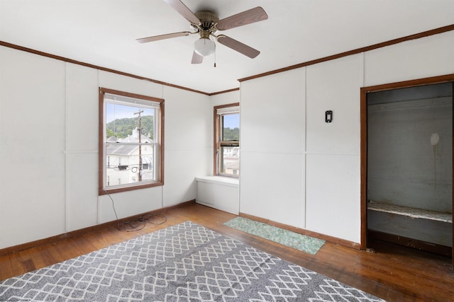 spare room with crown molding, light wood-type flooring, and ceiling fan