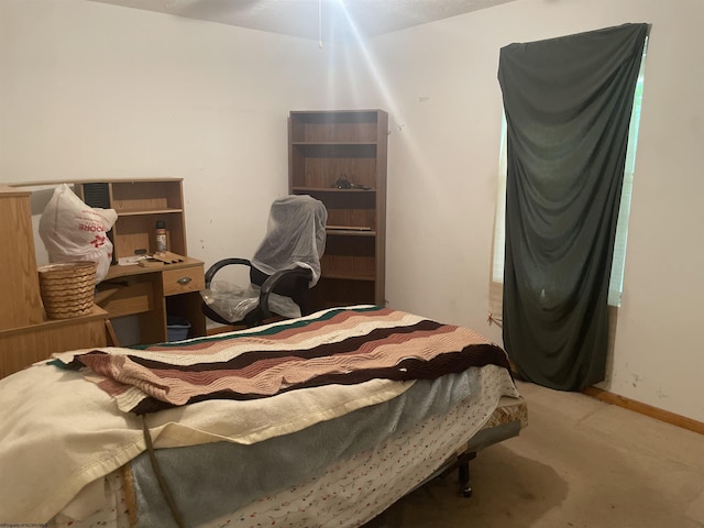 bedroom with carpet floors and baseboards