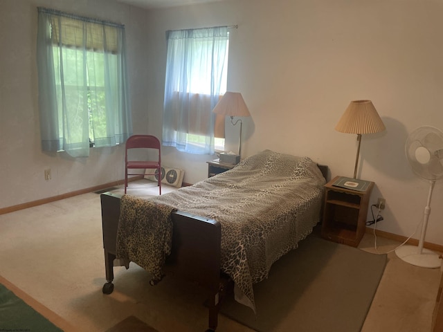 bedroom featuring carpet floors and baseboards