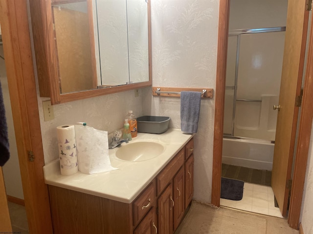 bathroom with shower / bath combination with glass door and vanity