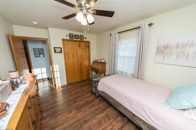 bedroom featuring radiator heating unit, dark wood-type flooring, ceiling fan, and a closet