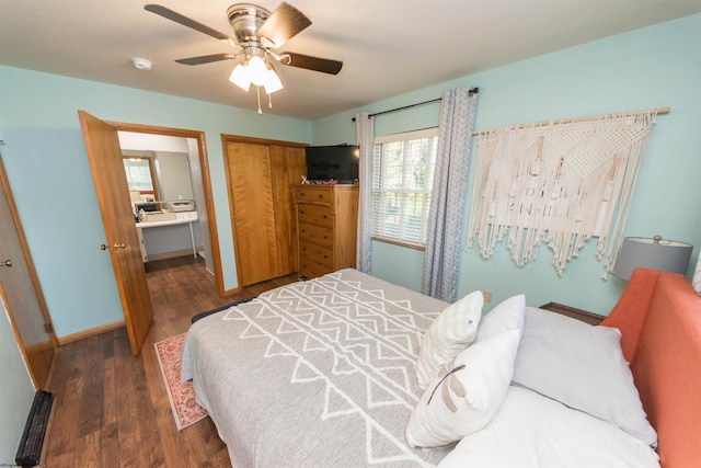 bedroom featuring ensuite bathroom, a closet, ceiling fan, and dark wood-type flooring