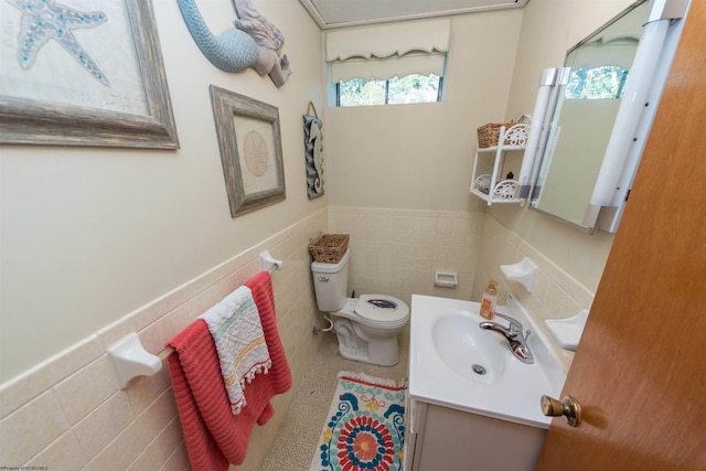 bathroom featuring vanity, toilet, backsplash, and tile walls