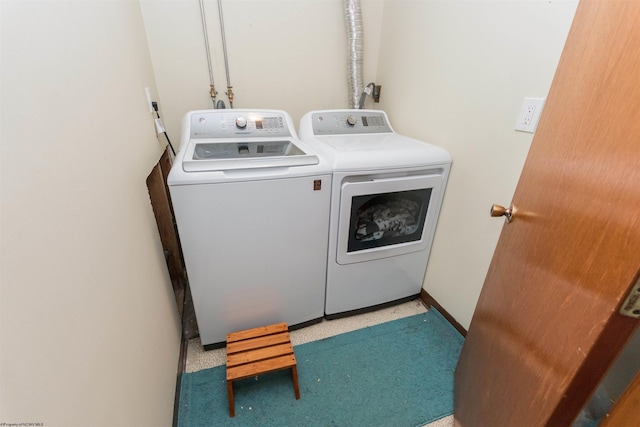 washroom with washing machine and clothes dryer