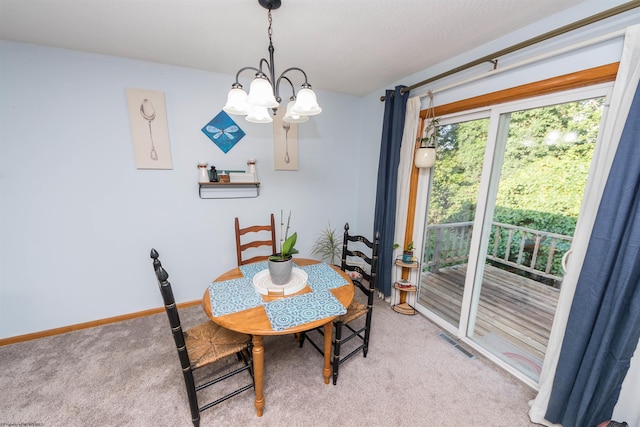 carpeted dining space with an inviting chandelier