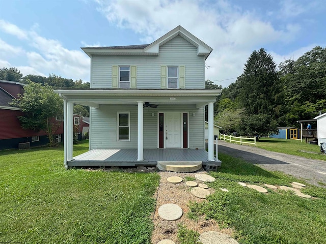 view of front of property featuring covered porch, a carport, and a front lawn