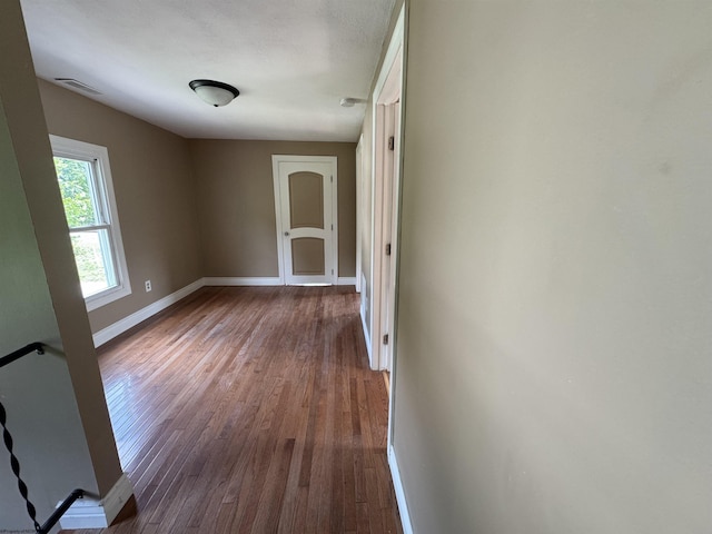 unfurnished room with hardwood / wood-style flooring