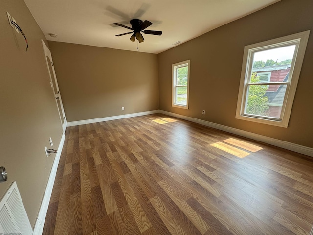 empty room with hardwood / wood-style flooring and ceiling fan