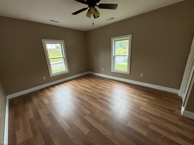 empty room featuring wood-type flooring and ceiling fan