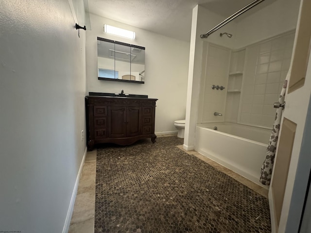 full bathroom featuring bathing tub / shower combination, tile patterned flooring, vanity, a textured ceiling, and toilet