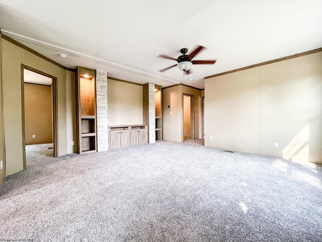 unfurnished bedroom with carpet, crown molding, and ceiling fan