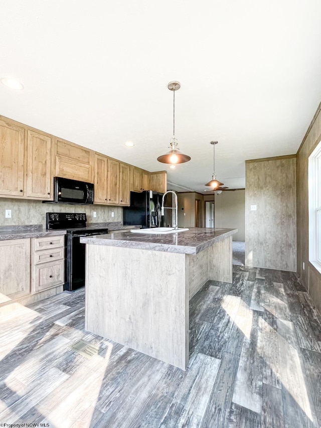 kitchen with a kitchen island with sink, black appliances, sink, light brown cabinetry, and pendant lighting