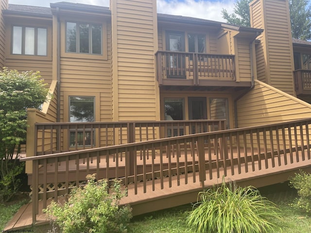 back of house with a wooden deck