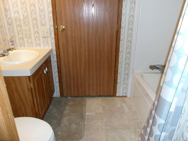 full bathroom featuring vanity, toilet, and shower / tub combo