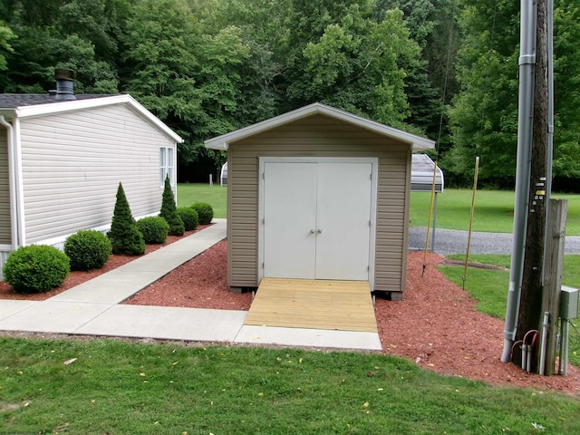 view of outbuilding featuring a lawn