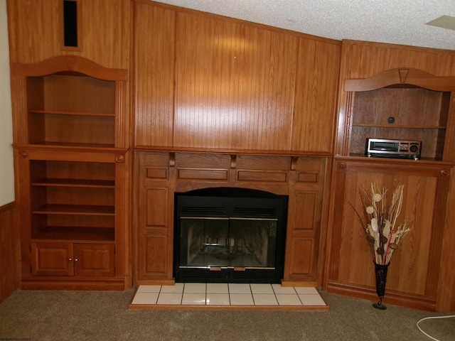 details with wooden walls, a fireplace, carpet floors, and a textured ceiling