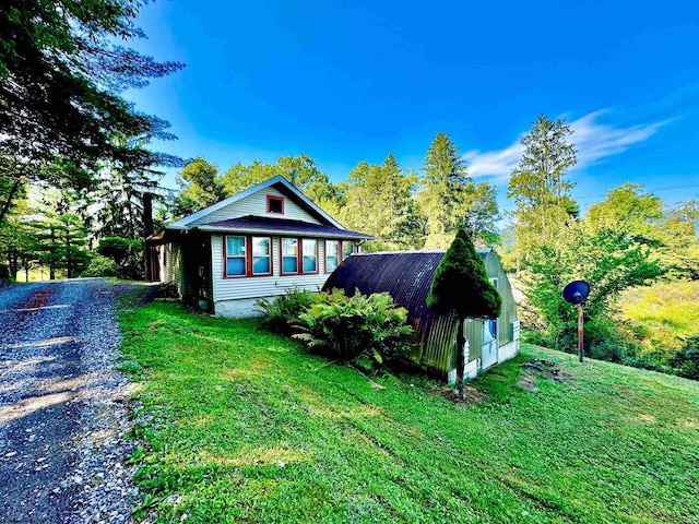 view of side of property with a yard