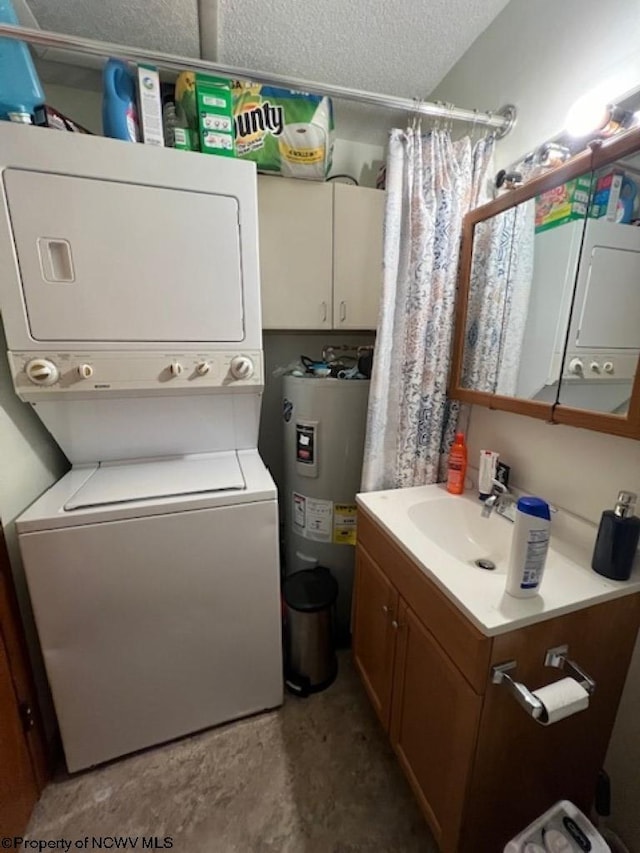 laundry room with laundry area, electric water heater, a textured ceiling, stacked washing maching and dryer, and a sink