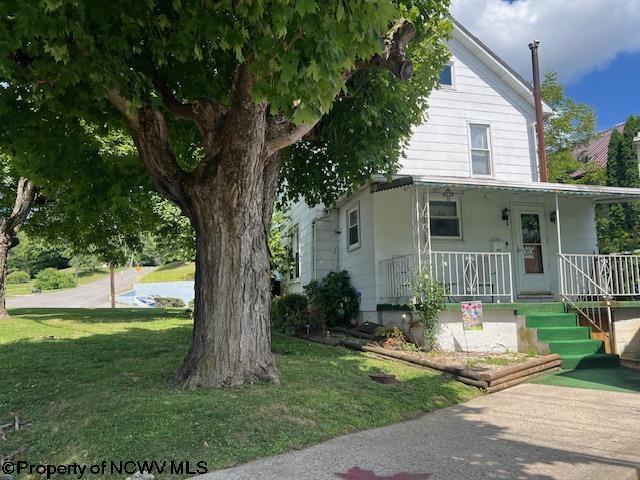 farmhouse with a porch and a front yard