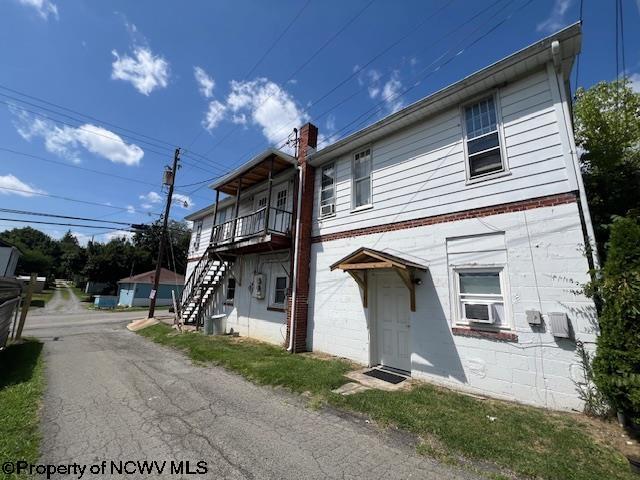 townhome / multi-family property with stairs and cooling unit