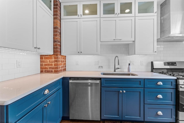 kitchen with tasteful backsplash, appliances with stainless steel finishes, sink, and wall chimney range hood