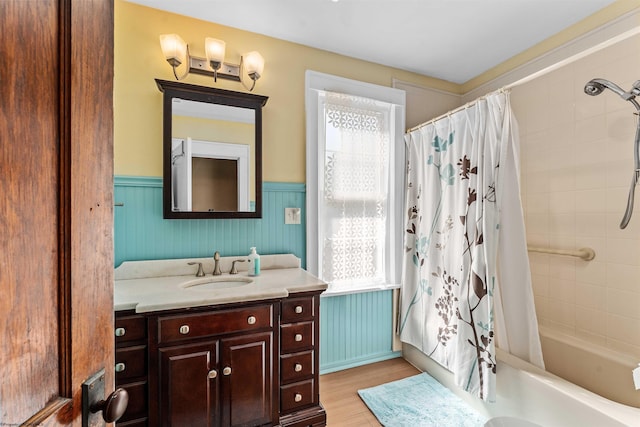 bathroom with vanity, wood-type flooring, a healthy amount of sunlight, and shower / bath combination with curtain